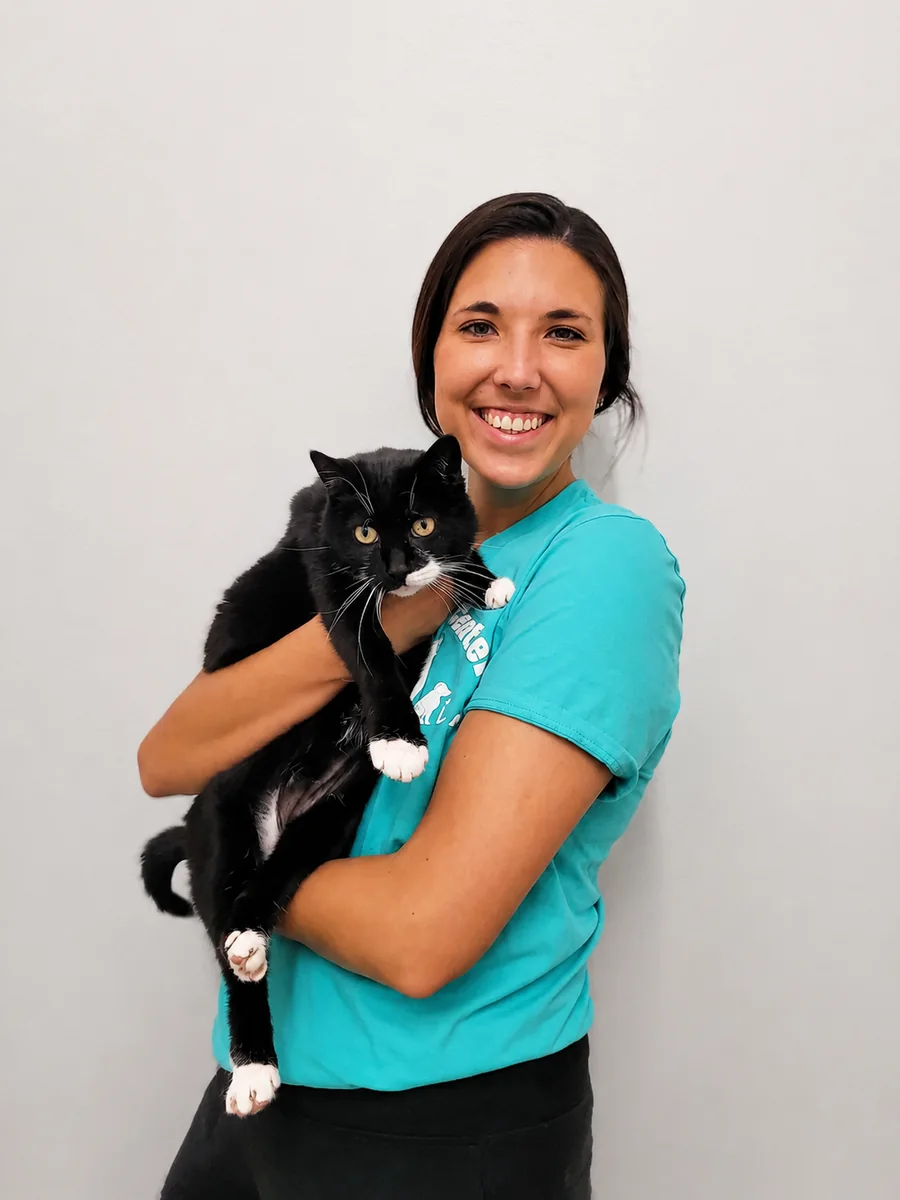 Ashley, Sales and Kennel Assistant, holding store cat Jade