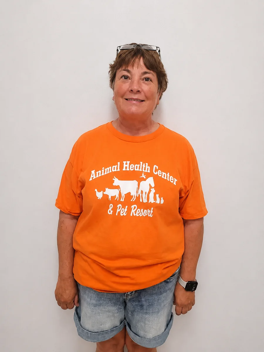 Kari, Sales and Kennel Assistant, in her orange Animal Health Center shirt