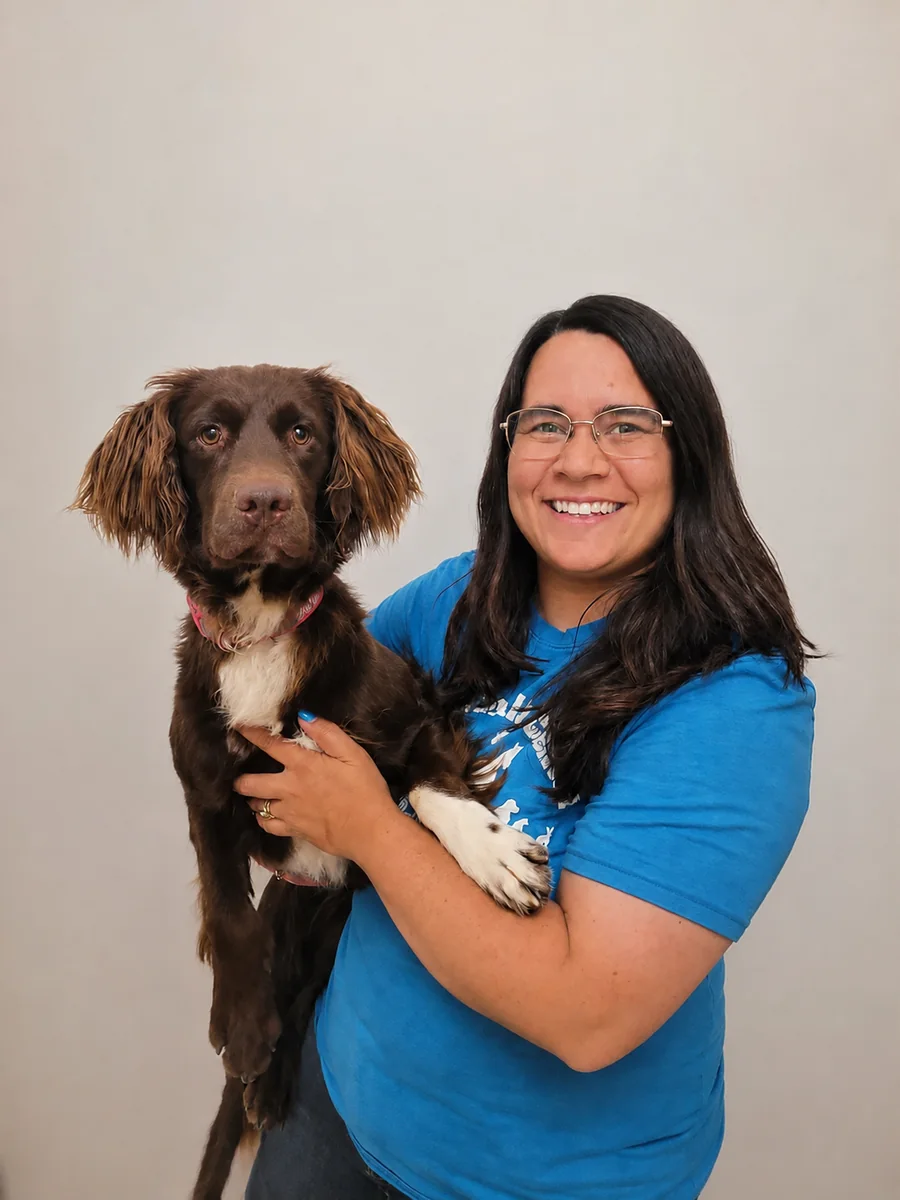Taylor, Kennel Manager, holding her dog Maple